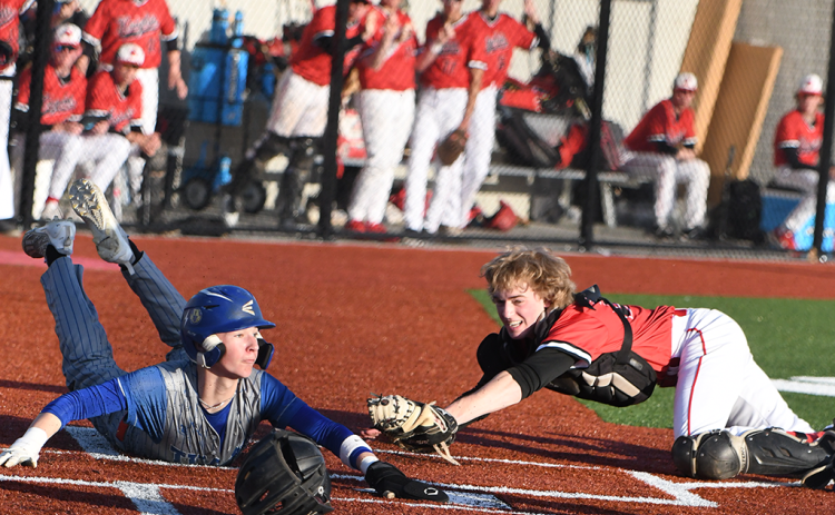 Boston Hinkle safely slides into home, giving the Titans their only run on Thursday. NCJ photo by Rick Holtz